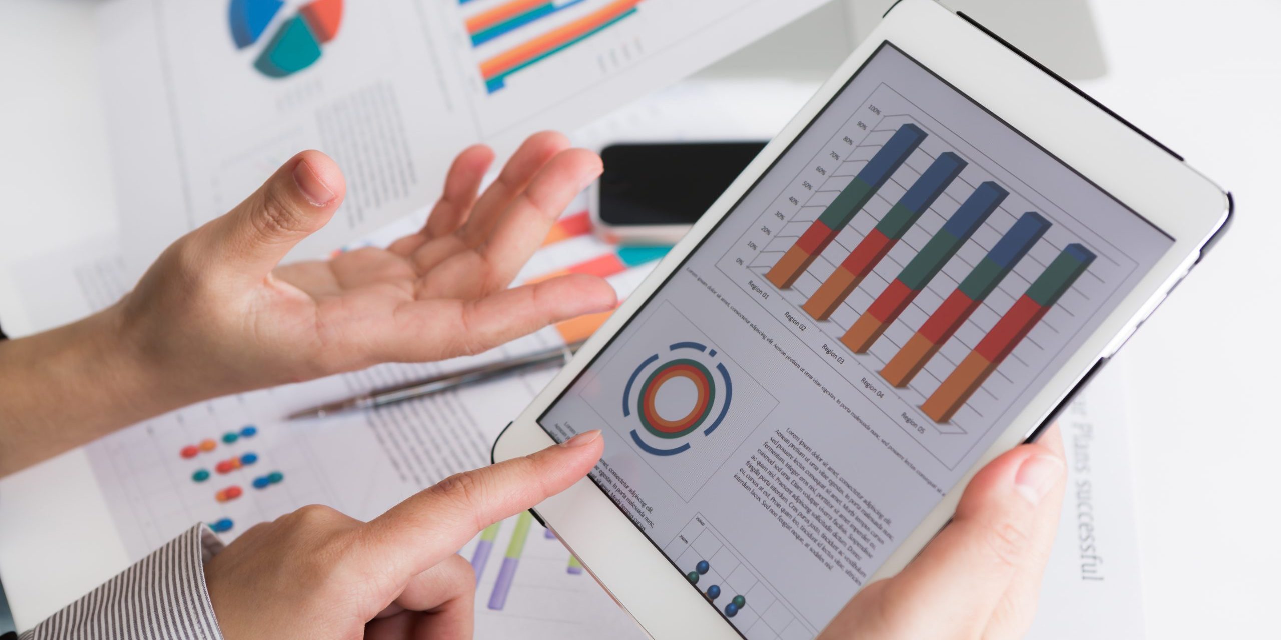 Close-up of business team using digital tablet with financial d